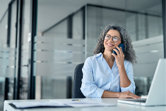 A woman smiling on the phone
